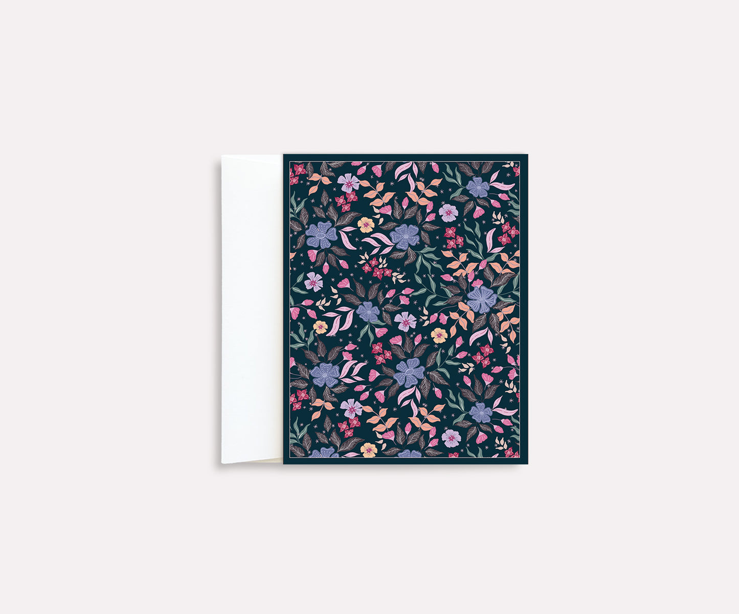A folded notecard with a vibrant floral pattern on a dark background, positioned against a plain background.